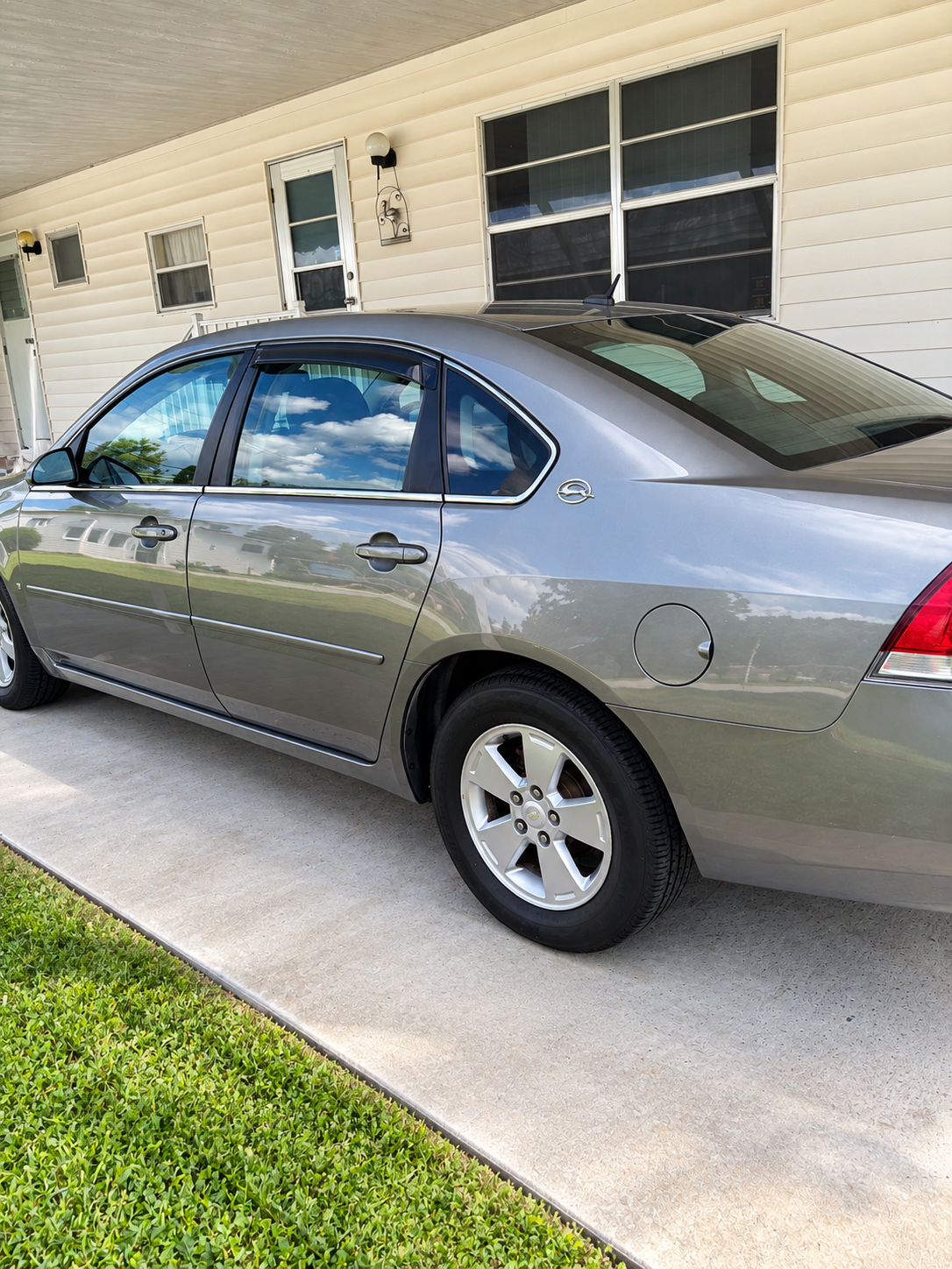 Detailed driver side of a gray sedan