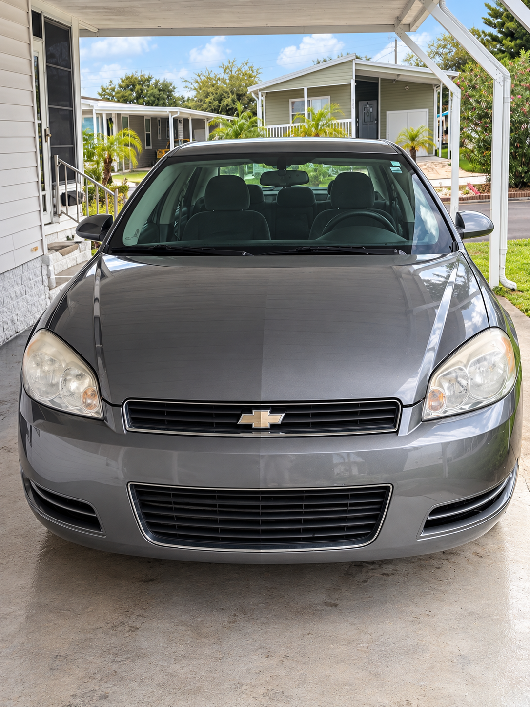 Freshly detailed gray Chevrolet sedan with a glossy exterior finish
