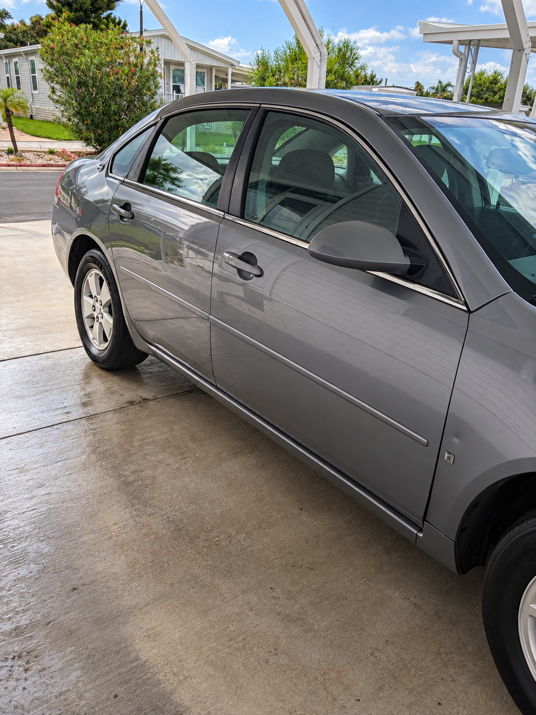 Detailed passenger side of a gray sedan