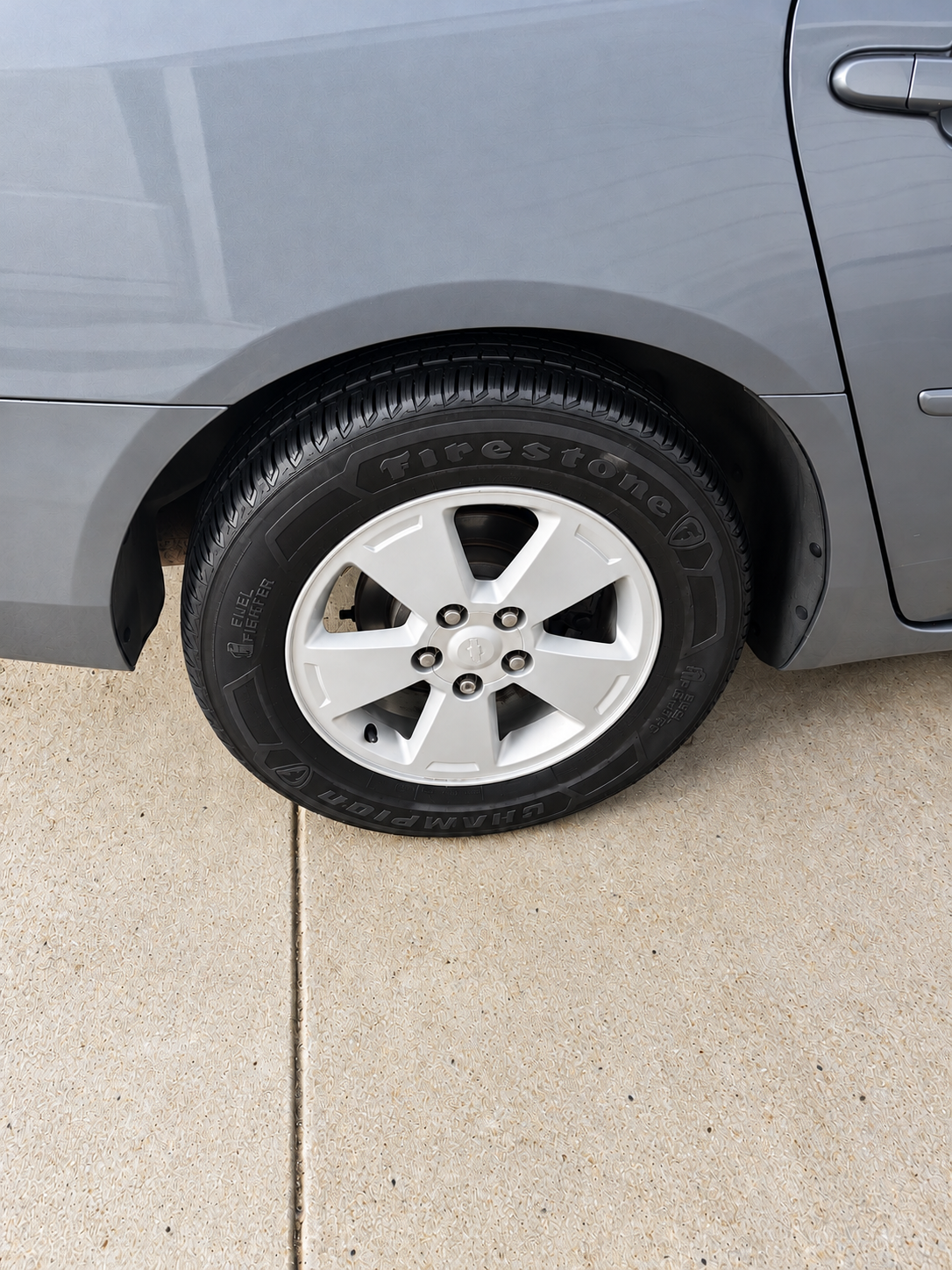 Clean bright alloy wheel and evenly dressed tire after professional detailing